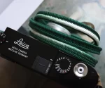 Crown Dark Green is a handmade camera neck strap made with Japanese kumihimo silk and genuine leather. Comfortable, durable, and ideal for premium cameras.