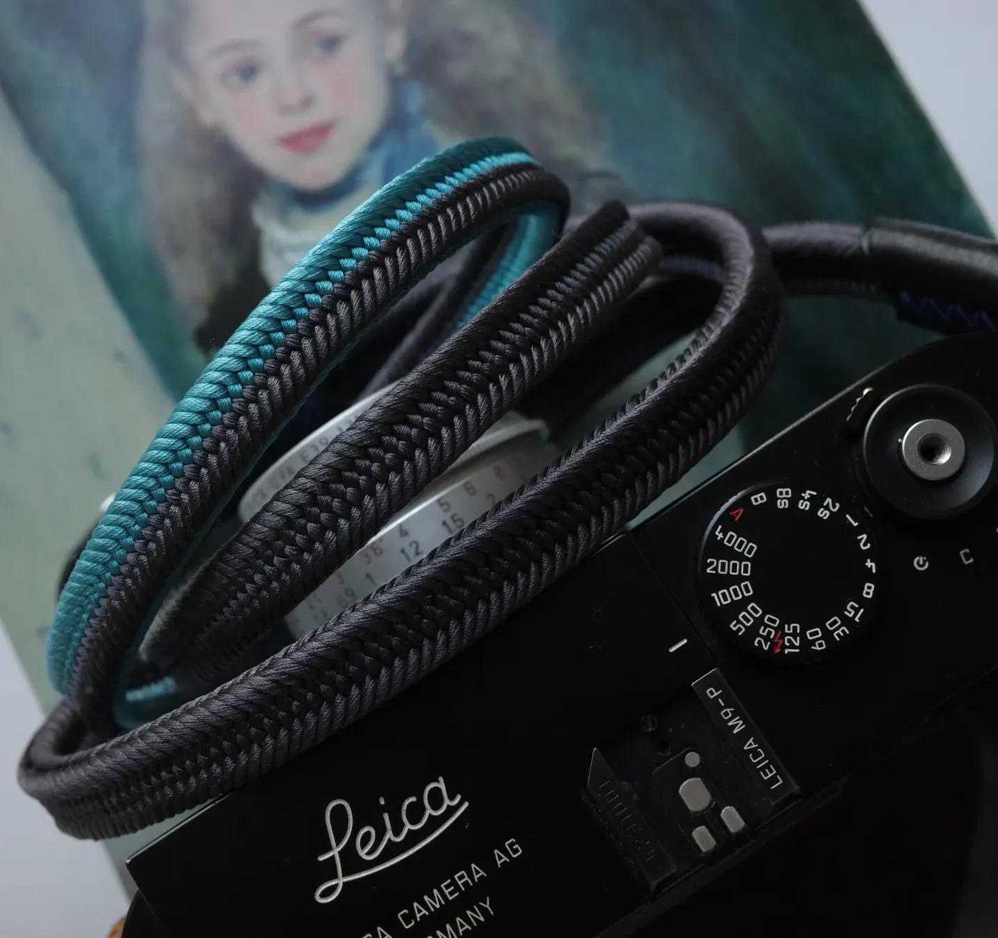 Crown Lividity Blue is a handmade camera neck strap made with Japanese kumihimo silk and genuine leather. Comfortable, durable, and ideal for premium cameras.