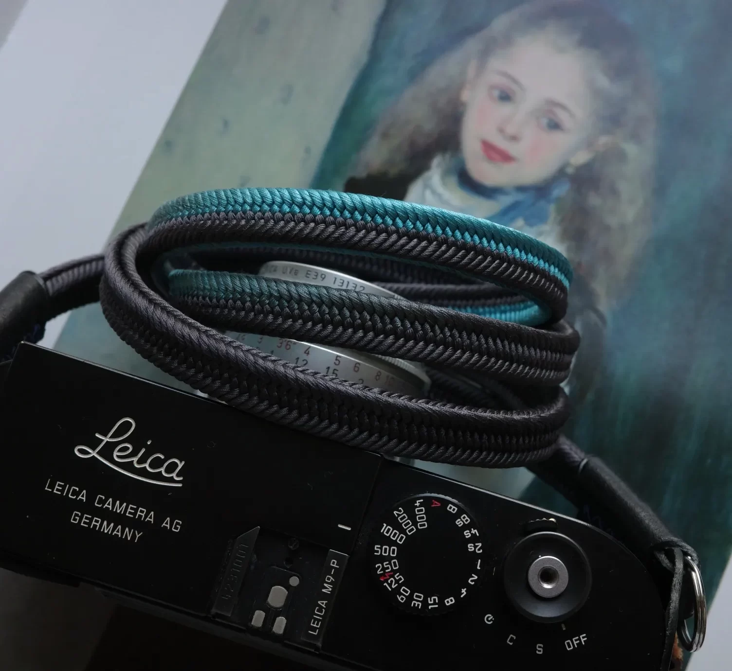 Crown Lividity Blue is a handmade camera neck strap made with Japanese kumihimo silk and genuine leather. Comfortable, durable, and ideal for premium cameras.