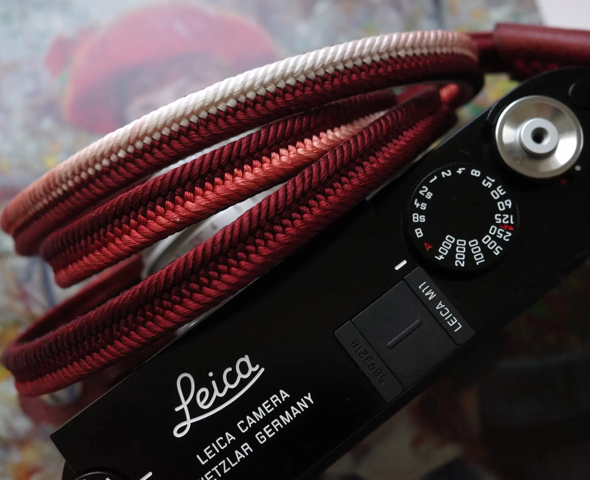 Crown Red is a handmade camera neck strap made with Japanese kumihimo silk and genuine leather. Comfortable, durable, and ideal for premium cameras.
